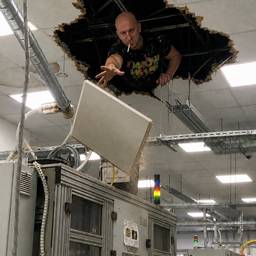 Man Throwing Ceiling Tile