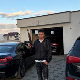 Holding an AK-47