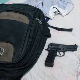 Gun Next to Backpack